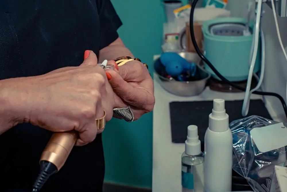 Hands inspecting a small manufactured component